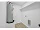 Utility room featuring a water heater and space for a washer and dryer at 639 N 102Nd Pl, Mesa, AZ 85207