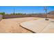 Large, enclosed backyard with a concrete patio and basketball hoop for recreational activities at 6505 S 15Th Dr, Phoenix, AZ 85041