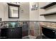 Unique half-bath boasts a glass bowl sink, decorative tile accents, and stylish fixtures at 6505 S 15Th Dr, Phoenix, AZ 85041