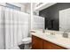 Bathroom featuring a black accent wall, vanity, and shower with tub combination at 6505 S 15Th Dr, Phoenix, AZ 85041
