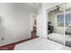 Bedroom featuring carpeted floors, a full-sized mirrored closet, and a window at 6505 S 15Th Dr, Phoenix, AZ 85041