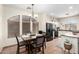 A charming dining room showcases a stylish chandelier, arched window, and wood table with seating for four at 6505 S 15Th Dr, Phoenix, AZ 85041
