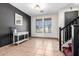 Neutral entryway with tile flooring, white table, stylish mirror, staircase and modern paint at 6505 S 15Th Dr, Phoenix, AZ 85041