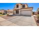 Charming two-story home with a two-car garage and low-maintenance desert landscaping in front at 6505 S 15Th Dr, Phoenix, AZ 85041