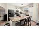 Spacious kitchen boasts a center island with barstool seating, sleek black appliances, and white cabinetry at 6505 S 15Th Dr, Phoenix, AZ 85041