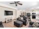 Inviting living room features an open floor plan with a ceiling fan, tile flooring, and neutral wall paint at 6505 S 15Th Dr, Phoenix, AZ 85041