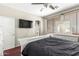 Comfortable bedroom features stylish furniture and access to a luxurious bathroom with natural light at 6505 S 15Th Dr, Phoenix, AZ 85041