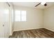 Neutral bedroom features wood flooring and a bright window at 6875 W Townley Ave, Peoria, AZ 85345