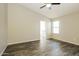 Bright bedroom features wood flooring, a large window, and neutral wall color at 6875 W Townley Ave, Peoria, AZ 85345
