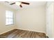 Neutral bedroom features wood flooring, ceiling fan, and natural light at 6875 W Townley Ave, Peoria, AZ 85345