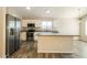 Modern kitchen with stainless steel appliances, granite countertops, white cabinets, and a central island at 6875 W Townley Ave, Peoria, AZ 85345