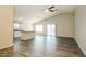 Open-concept living space with laminate floors, connecting the kitchen and living area seamlessly at 6875 W Townley Ave, Peoria, AZ 85345