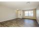 Bright, airy living room with laminate flooring, a front door, and large window at 6875 W Townley Ave, Peoria, AZ 85345