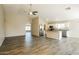 Open-concept living area features wood floors and a modern kitchen with stainless steel appliances at 6875 W Townley Ave, Peoria, AZ 85345