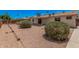Spacious backyard with desert landscaping and a covered patio area at 916 W Loughlin Dr, Chandler, AZ 85225