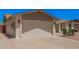 Attached two-car garage with ample space and lighting, complemented by desert-friendly landscaping at 916 W Loughlin Dr, Chandler, AZ 85225