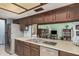 Well-lit kitchen with a stainless steel fridge and a view into the Gathering room at 916 W Loughlin Dr, Chandler, AZ 85225