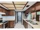 Traditional kitchen with wood cabinetry, stainless steel appliances, and double sink at 916 W Loughlin Dr, Chandler, AZ 85225
