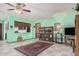 Cozy living room with tile flooring, ceiling fan, and pass-through window to the kitchen at 916 W Loughlin Dr, Chandler, AZ 85225