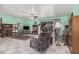 Comfortable living room featuring tile floors, a ceiling fan, and sliding glass doors to the backyard at 916 W Loughlin Dr, Chandler, AZ 85225