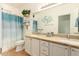 Bright bathroom features a double vanity, granite countertops, and a decorative accent wall detail at 9658 W Golddust Dr, Queen Creek, AZ 85144