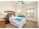 Bedroom features a window, carpet flooring, and a ceiling fan at 9658 W Golddust Dr, Queen Creek, AZ 85144