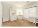 Bright bedroom with white furniture, carpeted floors, and a ceiling fan at 9658 W Golddust Dr, Queen Creek, AZ 85144