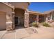 Welcoming front entrance with stone pillars, desert plants and a charming covered porch, showcasing inviting curb appeal at 9658 W Golddust Dr, Queen Creek, AZ 85144