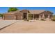 Inviting single-story home with a tan exterior, stone accents, and a desert landscape providing an inviting appeal at 9658 W Golddust Dr, Queen Creek, AZ 85144