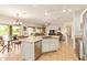 Open concept kitchen features an island with sink and stainless steel appliances at 9658 W Golddust Dr, Queen Creek, AZ 85144