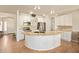 Bright kitchen with a curved island, stainless steel appliances, and tile flooring at 9658 W Golddust Dr, Queen Creek, AZ 85144