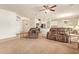 Spacious living room with carpet, neutral walls, and an open floor plan leading to the kitchen and dining area at 9658 W Golddust Dr, Queen Creek, AZ 85144