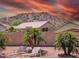 Palm trees and desert landscaping with lounge chairs for relaxing in the backyard at 11424 S Obispo Dr, Goodyear, AZ 85338