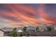 View of the back of the home with desert landscaping, palm trees, and privacy wall at 11424 S Obispo Dr, Goodyear, AZ 85338