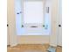 Bright bathroom with a built-in tub beneath a window at 11424 S Obispo Dr, Goodyear, AZ 85338