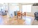 Inviting dining area with a wooden table and chairs, tile flooring, and abundant natural light at 11424 S Obispo Dr, Goodyear, AZ 85338