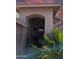 Welcoming entryway with covered porch, beautiful doorframe, and lush desert foliage at 11424 S Obispo Dr, Goodyear, AZ 85338