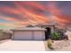 Charming single-story home with a desert landscape and a spacious three-car garage at 11424 S Obispo Dr, Goodyear, AZ 85338