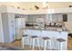 Eat-in kitchen features gray cabinets, light countertops, modern appliances, and breakfast bar at 11424 S Obispo Dr, Goodyear, AZ 85338