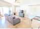 Spacious living room with tile floors, a comfortable sofa, and a sliding door to the outdoors at 11424 S Obispo Dr, Goodyear, AZ 85338