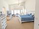 Spacious main bedroom with a ceiling fan, many windows, and carpet flooring at 11424 S Obispo Dr, Goodyear, AZ 85338