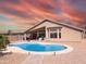 Backyard pool with desert landscaping and covered patio for outdoor entertaining at 11424 S Obispo Dr, Goodyear, AZ 85338