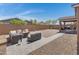 Cozy backyard featuring outdoor seating arranged around a fire pit, with a patio and BBQ grill at 1221 E Jahns Dr, Casa Grande, AZ 85122