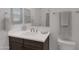 Bright bathroom featuring a white countertop, dark wood cabinets, and neutral-toned towels at 1221 E Jahns Dr, Casa Grande, AZ 85122