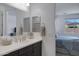 Bright bathroom with a dual vanity, white countertops, and a view into the bedroom at 1221 E Jahns Dr, Casa Grande, AZ 85122