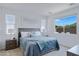Bright primary bedroom with two windows, a plush bed and views to the backyard at 1221 E Jahns Dr, Casa Grande, AZ 85122
