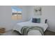 Bright bedroom with a plush bed, stylish throw pillows, and a view to the backyard at 1221 E Jahns Dr, Casa Grande, AZ 85122