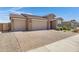 Attractive home exterior showcasing a spacious three-car garage and brick driveway at 1221 E Jahns Dr, Casa Grande, AZ 85122