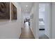 Well-lit hallway with wood floors, connecting to bedrooms and living spaces at 1221 E Jahns Dr, Casa Grande, AZ 85122