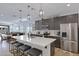 Modern kitchen with stainless steel appliances, large island with seating, and stylish pendant lighting at 1221 E Jahns Dr, Casa Grande, AZ 85122
